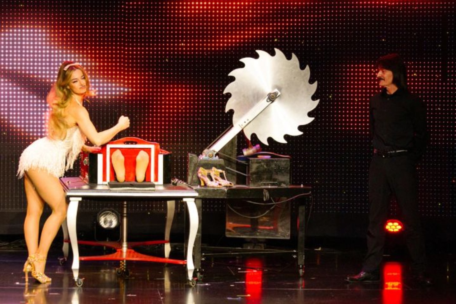 Performers with a large circular saw illusion in Allstars of Magic in Las Vegas