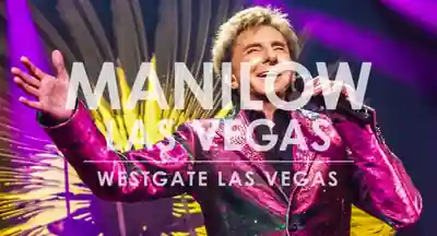 Barry Manilow seated at a piano during his Las Vegas show