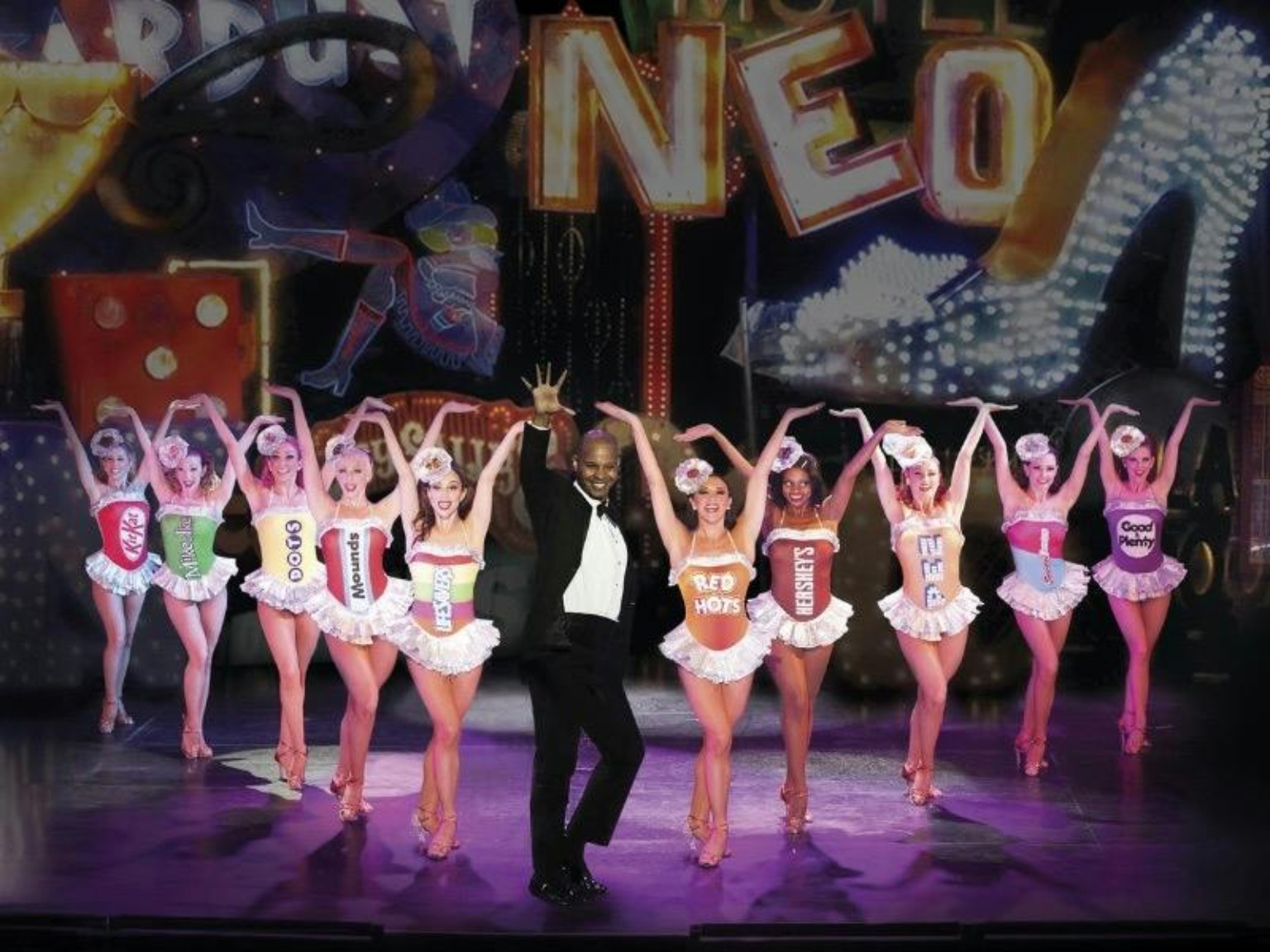 VEGAS! The Show dancers in candy costumes onstage at Saxe Theater Las Vegas